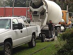 mixer dumping concrete to pump